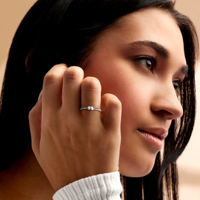 Model wearing 14kt white gold ring with two lab-grown diamonds on a slim band