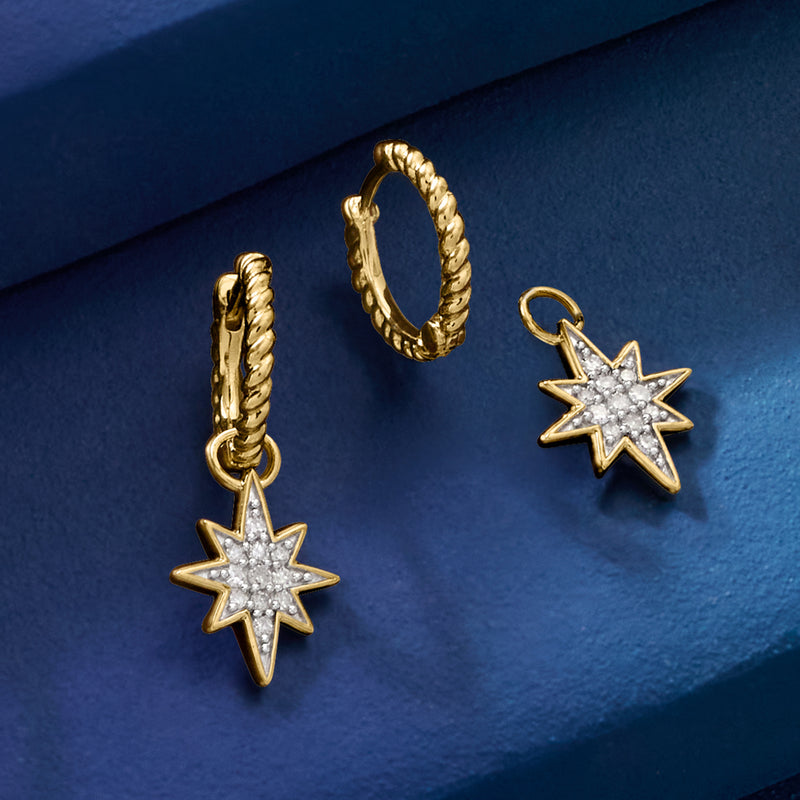Gold hoop earrings with dangling star charms and faceted clear stone centers