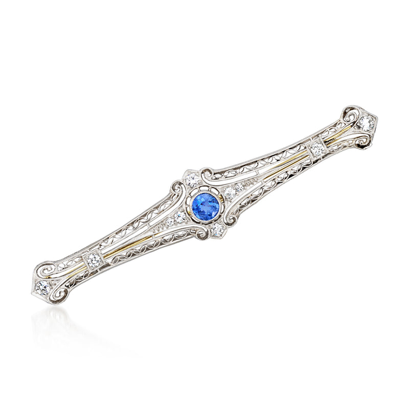 Vintage platinum pin with oval blue sapphire center and diamond accents, bar design