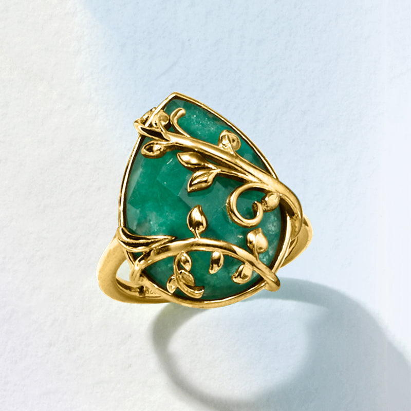 Gold emerald-green oval gemstone ring with openwork vine and leaf accents