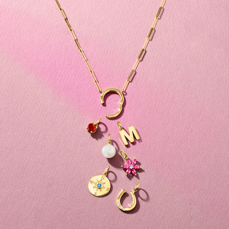 Pink topaz flower charm with white sapphire center on yellow gold chain, with other charms