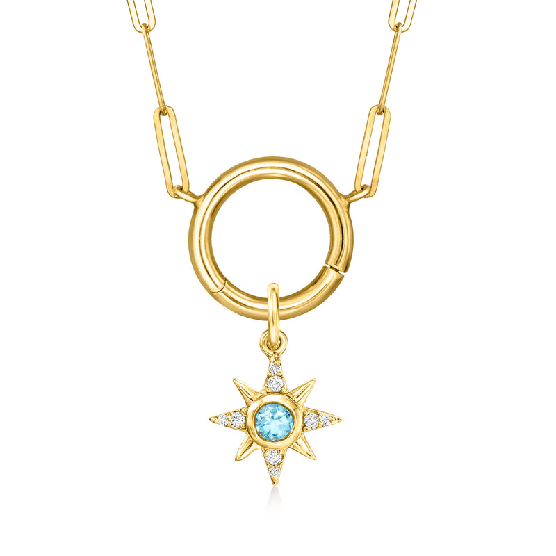 14kt yellow gold starburst charm with blue gemstone center on linked chain