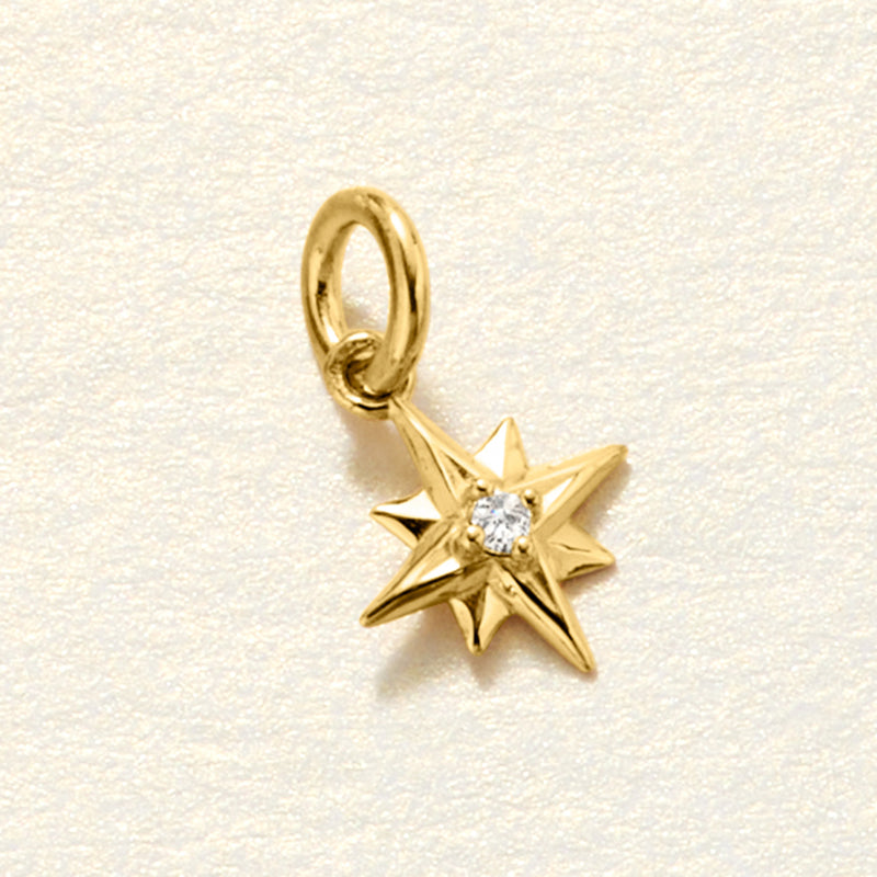Close-up: 14kt yellow gold star charm with small diamond center and loop bail