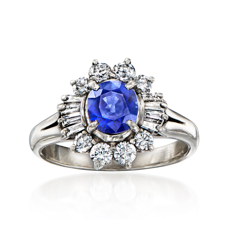 Platinum ring with round blue sapphire center and diamond halo and side accents
