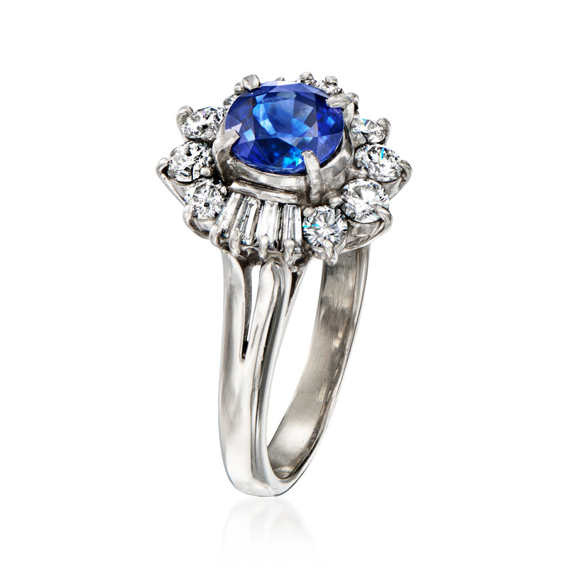Platinum ring with round blue sapphire center, baguette and round diamond halo