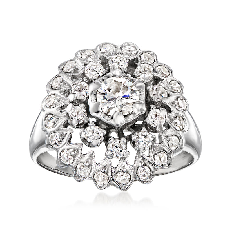 Vintage diamond cluster ring in white gold with round center stone and halo of small diamonds