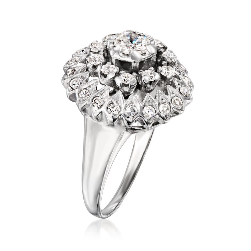 White gold diamond cluster ring with textured halo and raised round center stone, side view