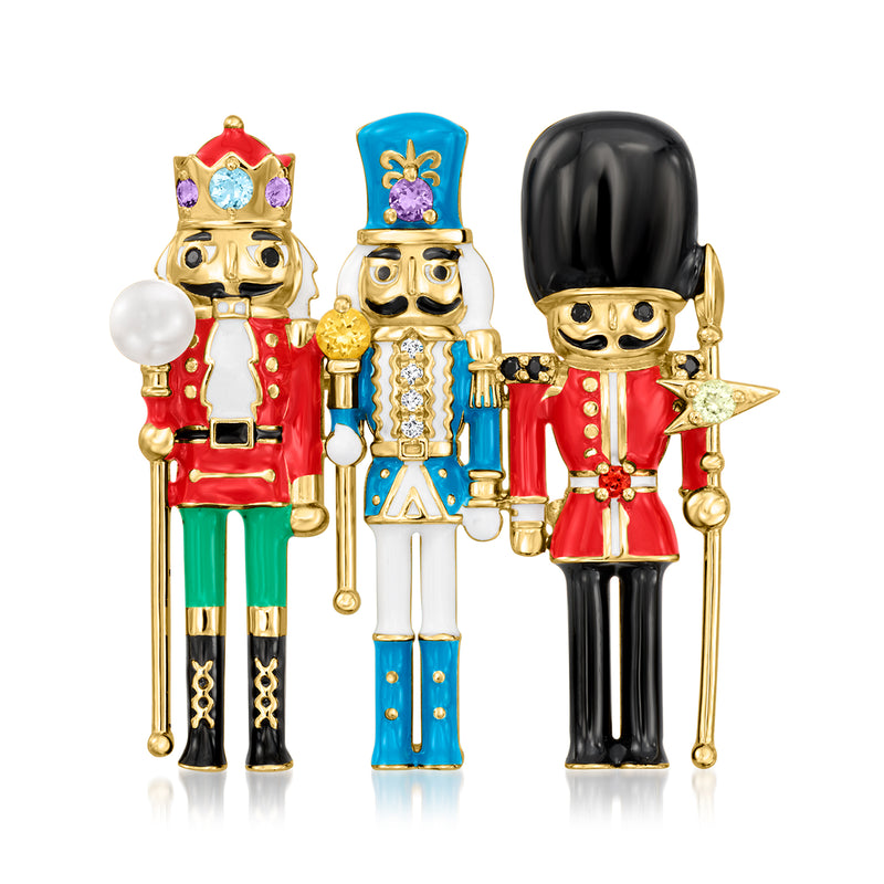 Nutcracker pin with red, blue, and black enamel gold-tone figures and white pearl