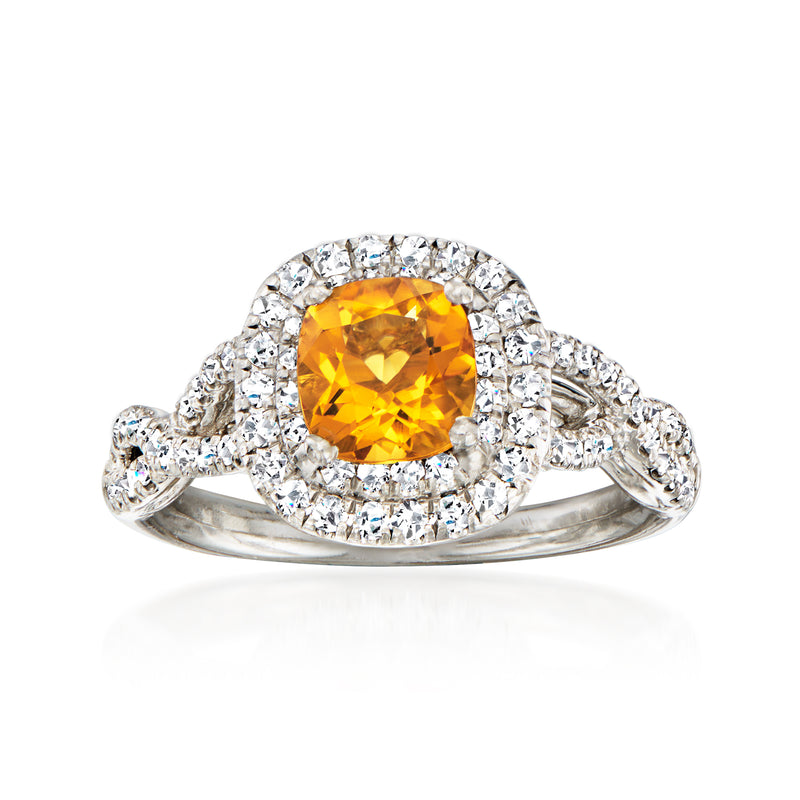 Platinum vintage ring with oval citrine center and diamond halo, prong-set on tapered band
