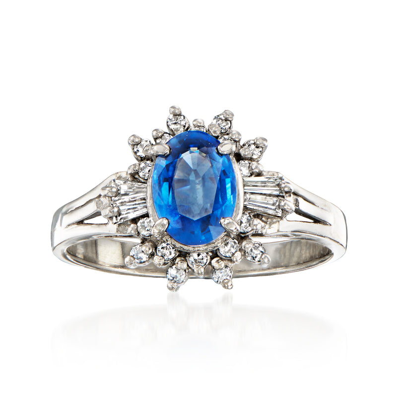 Platinum ring with oval blue sapphire center and diamond halo cluster