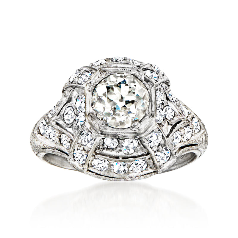 Vintage platinum filigree diamond ring with oval center stone and round side diamonds