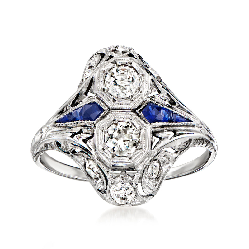 Vintage white gold ring with round diamonds, three-stone design, and blue sapphire accents