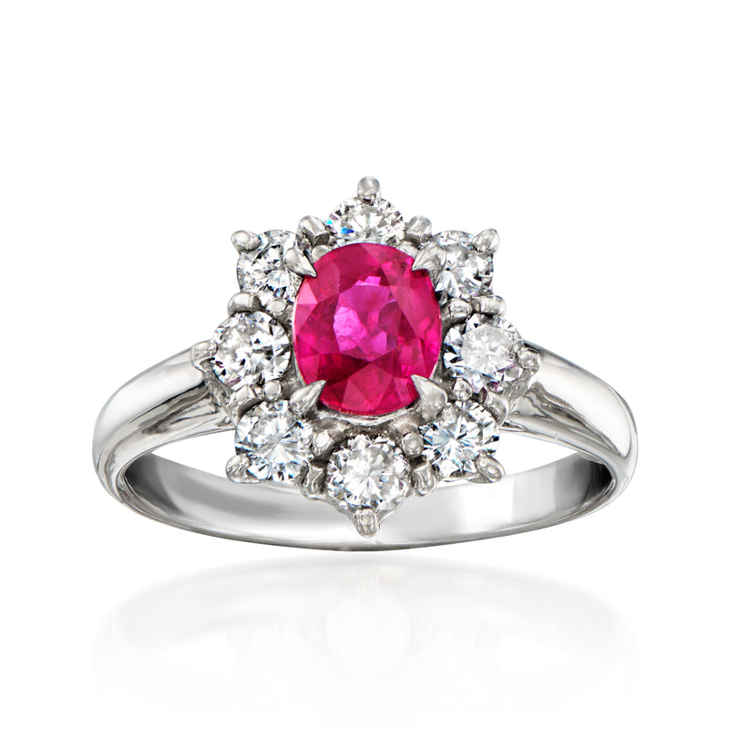 Platinum ring with oval pink ruby center and diamond halo, with round side diamonds