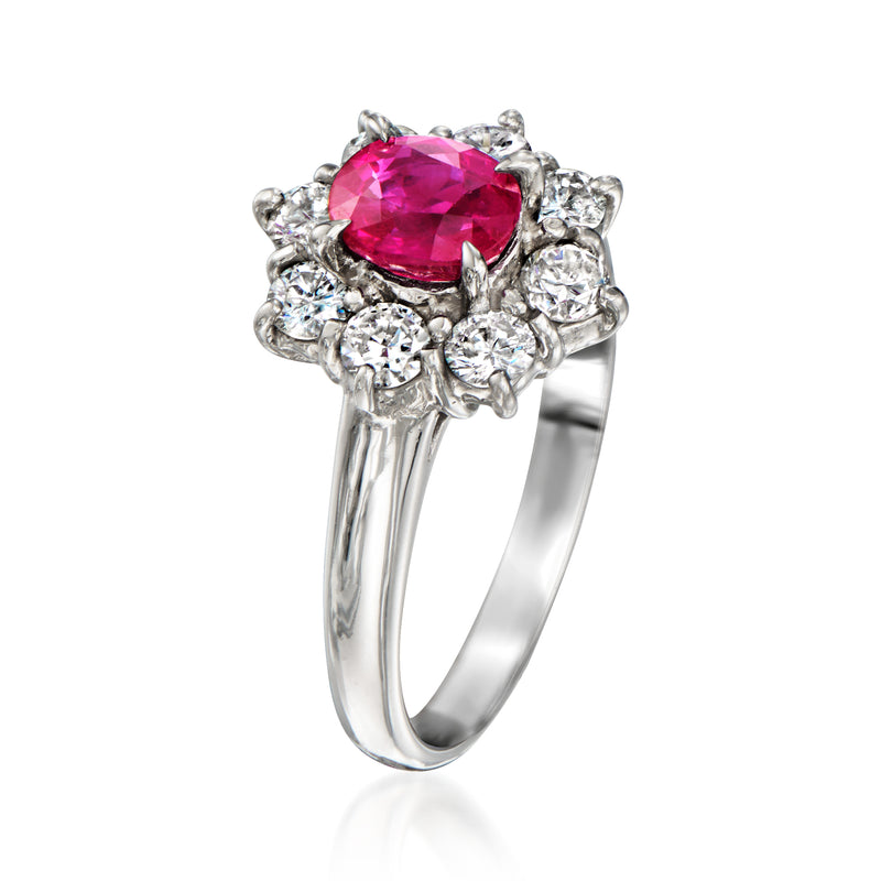 Platinum ring featuring oval pink ruby center with clustered round diamonds around