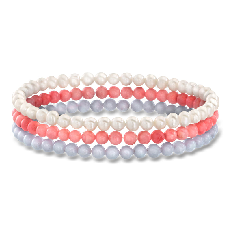 Three beaded stretch bracelets: white pearl, coral pink, and light blue beads