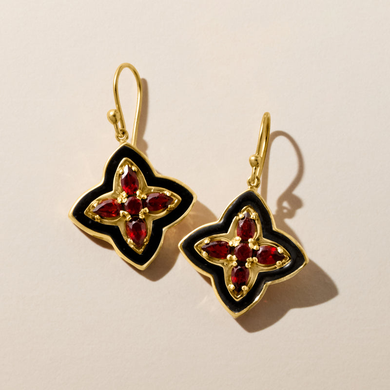 Gold clover drop earrings, black enamel frames with red gemstone accents