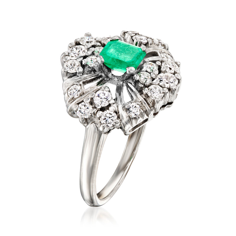 Platinum diamond halo ring with emerald-cut center stone and curved split shank