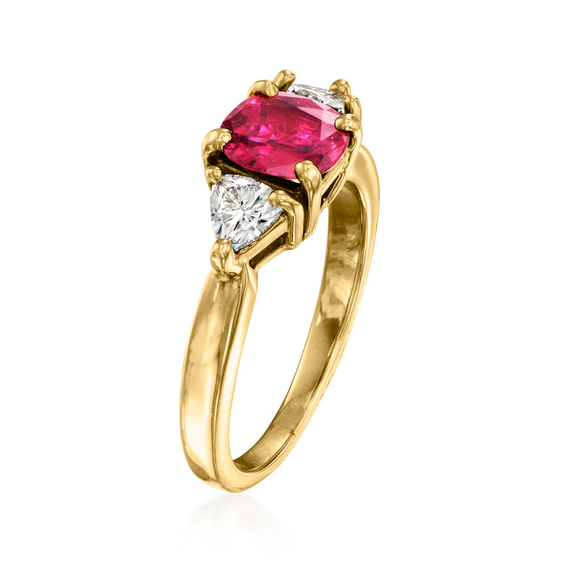 Yellow gold ring with oval pink ruby center and two round diamond side stones