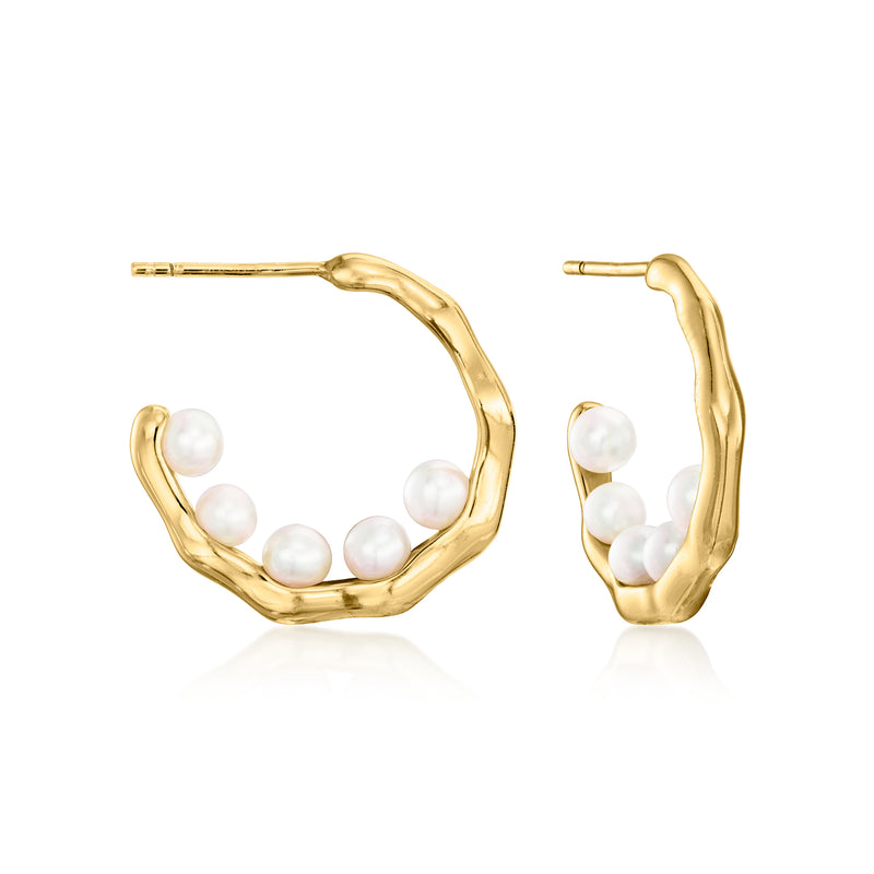 Gold hoop earrings with small round cultured pearls set along the hoops