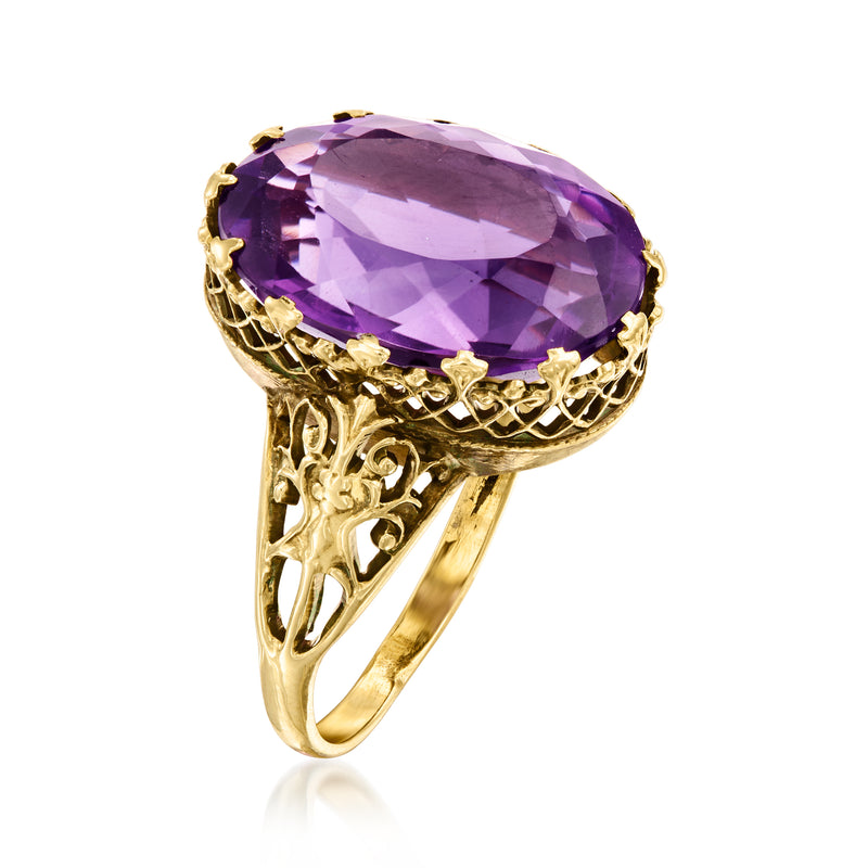 Amethyst oval gemstone ring with purple stone, gold prong setting and ornate scrollwork