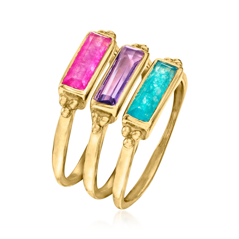 Set of three gold-tone rings with rectangular pink, purple, and turquoise gemstones