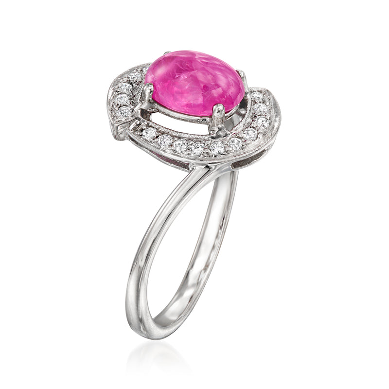 Pink ruby oval set in diamond halo, openwork white gold ring band