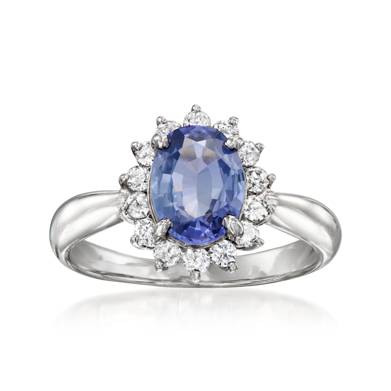 Platinum vintage ring with oval blue sapphire center and round diamond halo and split shoulders