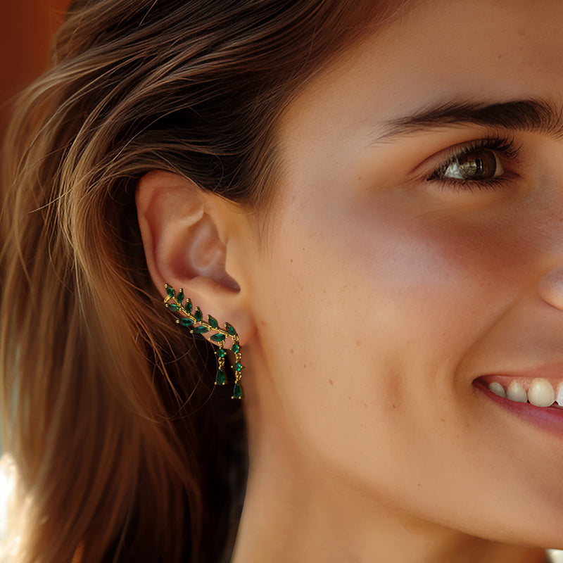 Green leaf-and-vine drop earrings on model ear, gold over sterling with teardrop stones