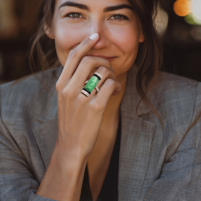 Green jade cylinder ring with black onyx bands and diamond accents on finger, white gold