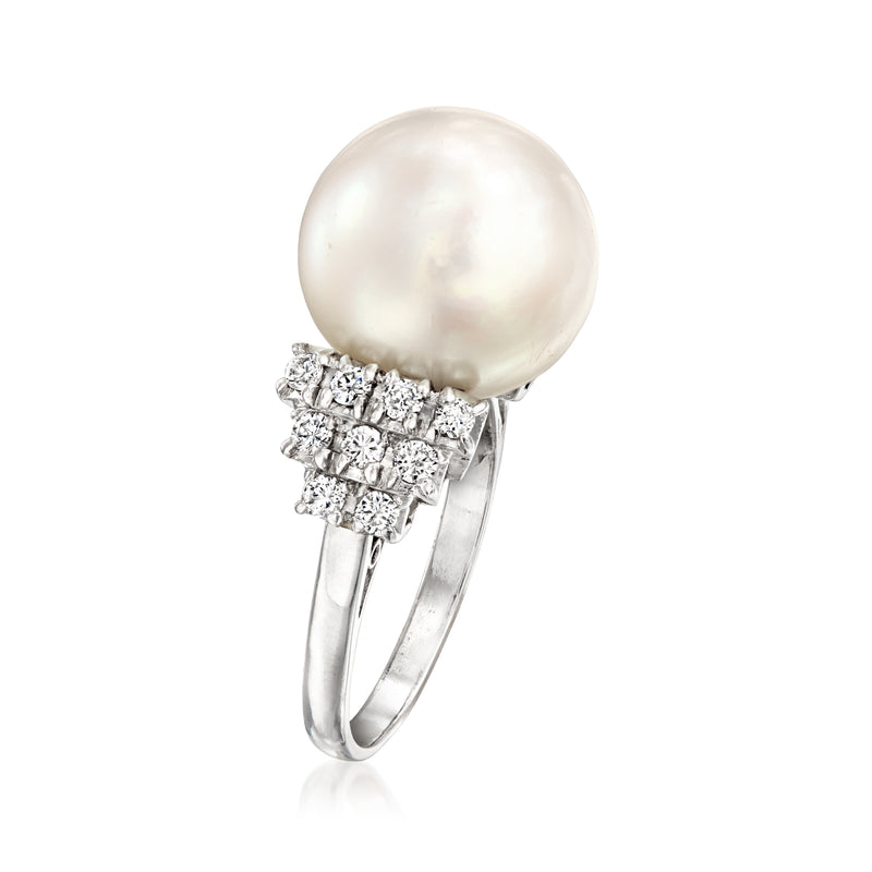 Platinum ring with round white pearl set in square diamond halo