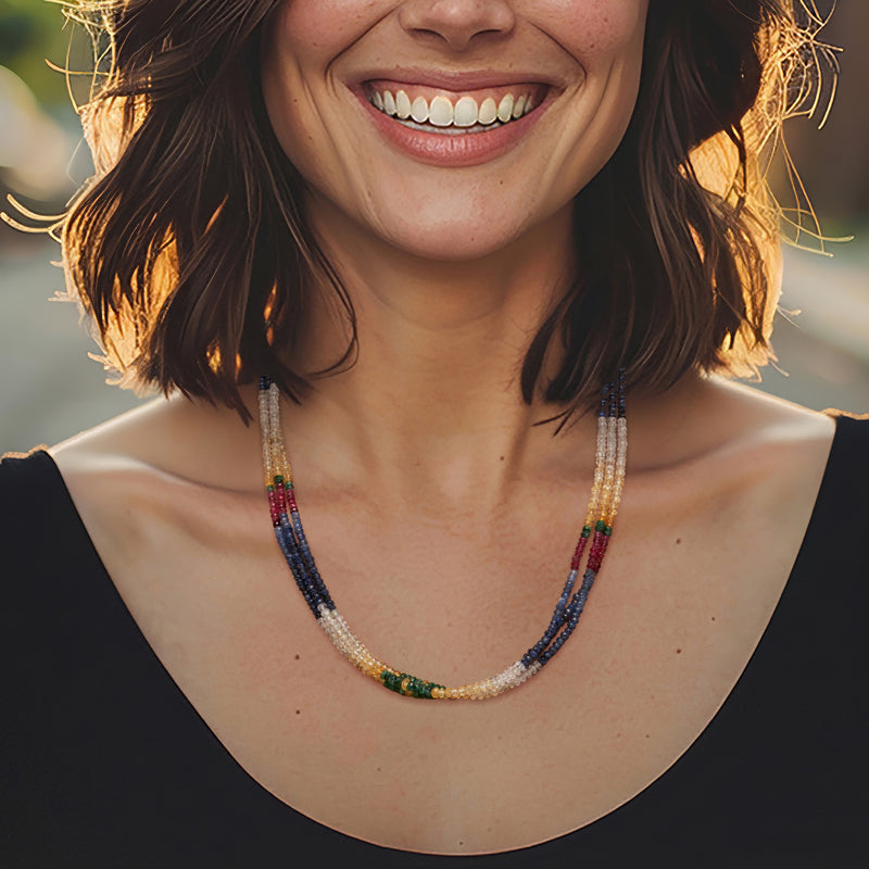Multicolored bead necklace worn on neckline, layered bead rows in blue and white