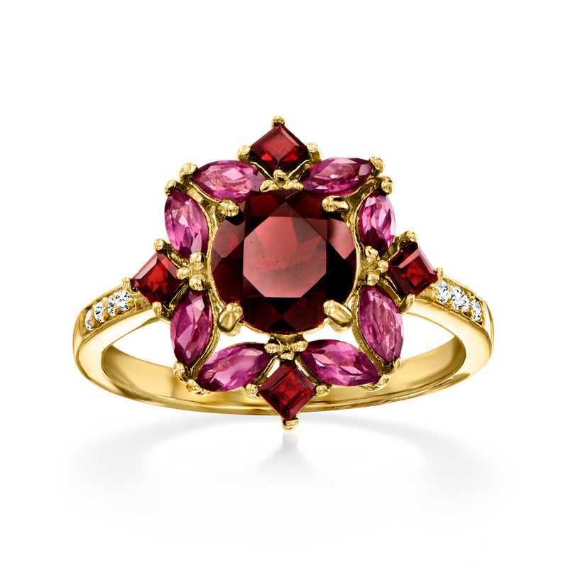 Gold ring with red and pink gemstones; dark center stone and small white topaz accents
