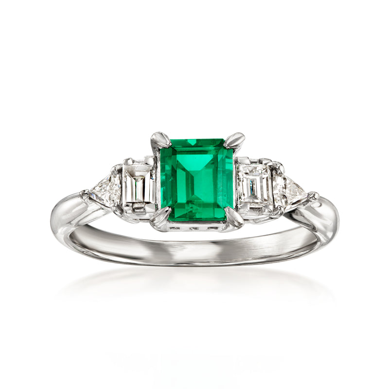 Platinum ring with emerald-cut green gemstone and square diamond side stones