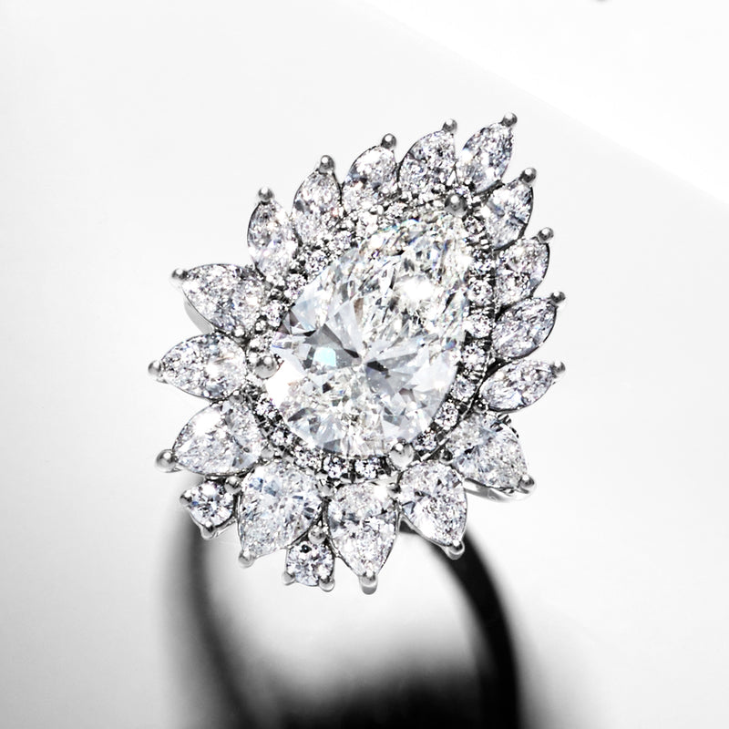 14kt white gold halo diamond ring with prong-set center stone and surrounding stones