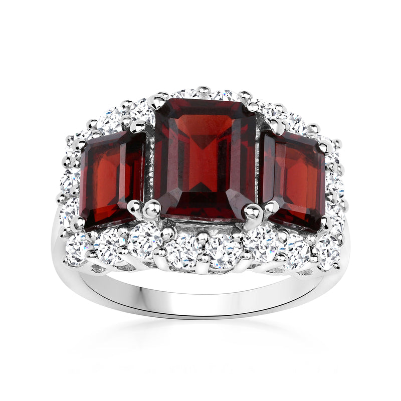 Sterling silver three-stone ring with red garnet center and white topaz accents