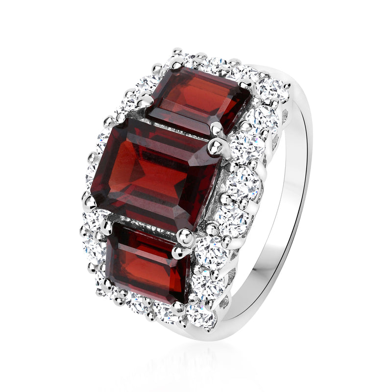 Sterling silver three-stone ring with red emerald-cut garnets and white topaz halos