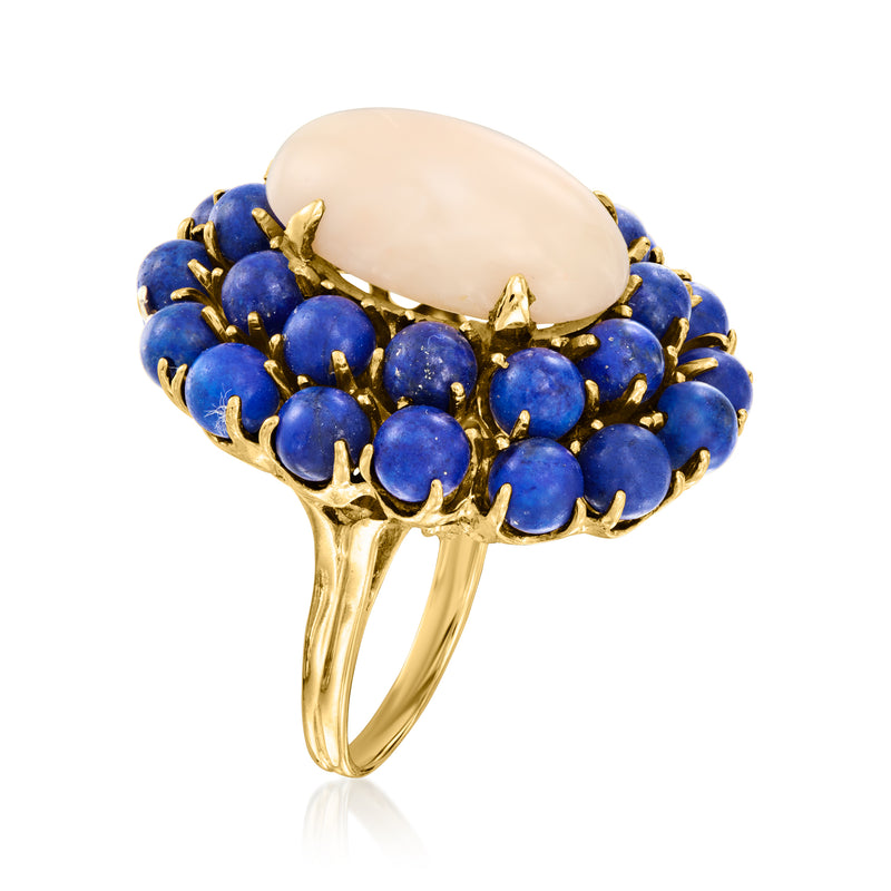 Yellow gold ring with oval pale center and blue lapis cabochon around the band