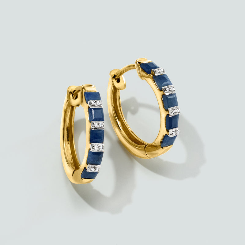 Pair of gold hoop earrings with blue sapphire insets and diamond detail rows