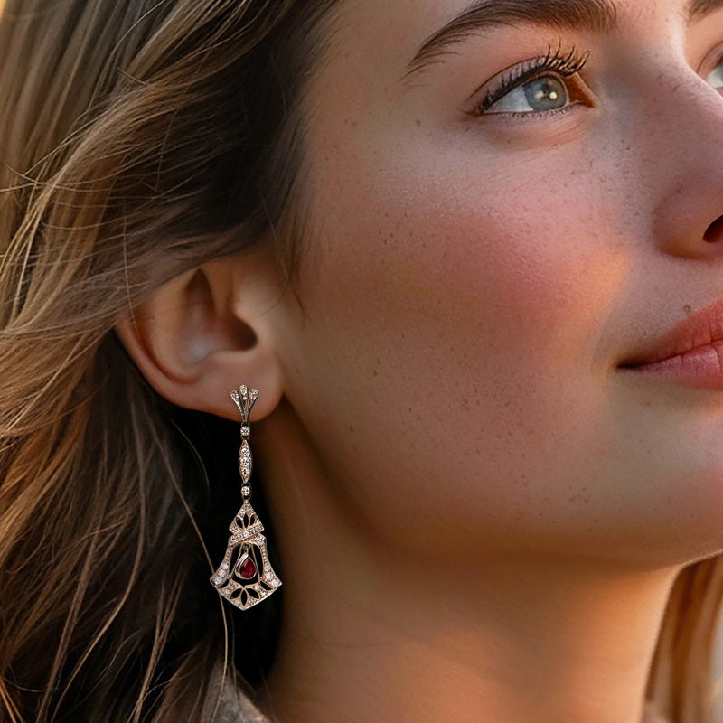 Diamond and teardrop ruby drop earrings on model, platinum chandelier-style setting