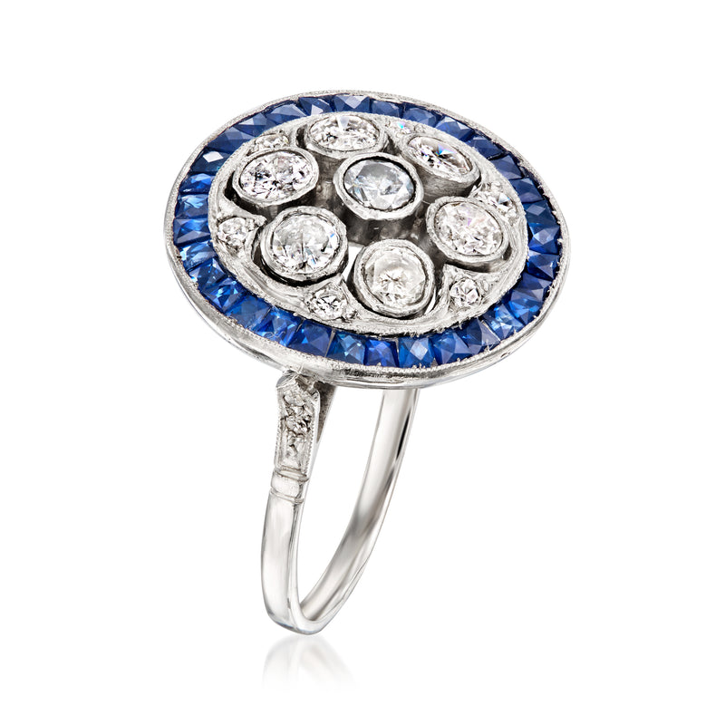 Platinum ring with blue sapphire rim and circular diamond cluster top