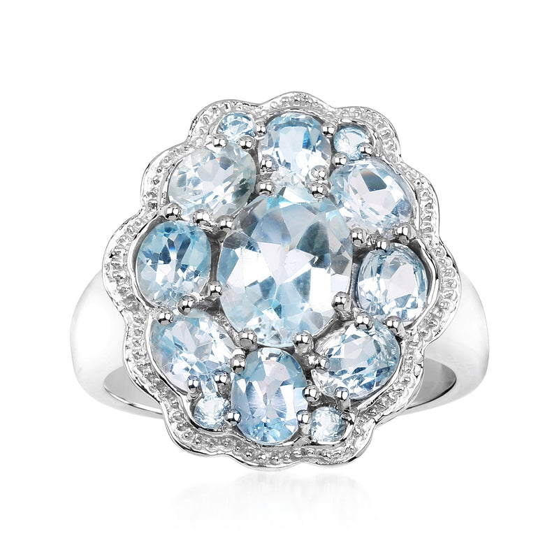Sterling silver flower ring with oval sky-blue topaz stones in a prong setting