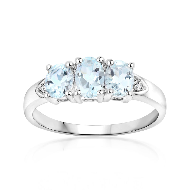 Three-stone aquamarine ring in sterling silver with diamond accents, rounded settings