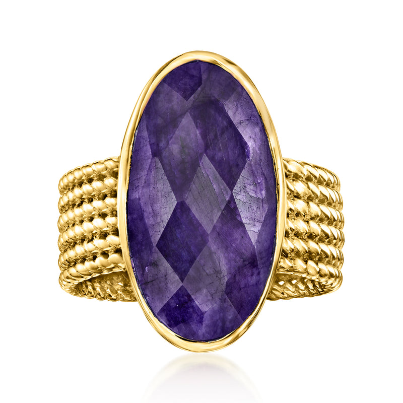 Oval purple sapphire ring with braided gold band in teardrop setting