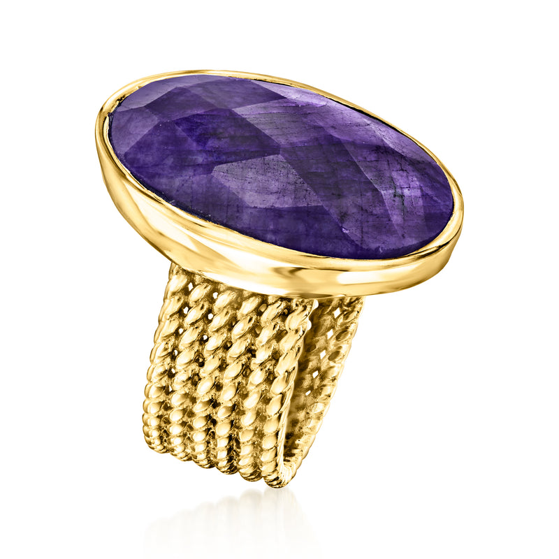 Purple oval sapphire ring with bezel setting and textured gold braided band