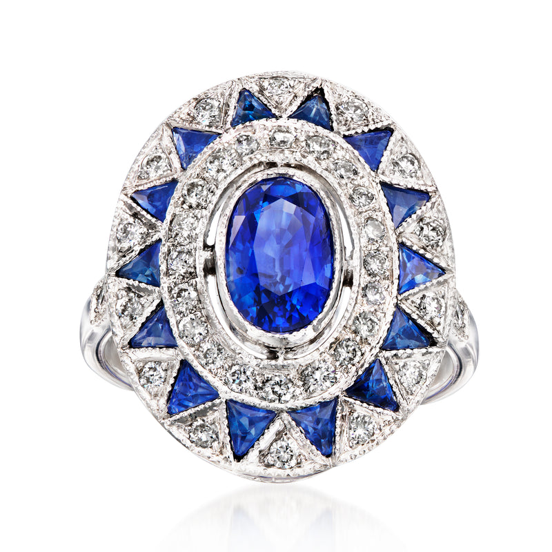 Ring with oval blue sapphire center, diamond halo and blue side stones, white gold
