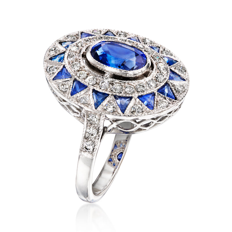 Oval blue sapphire ring with diamond halo, blue side stones, white gold band
