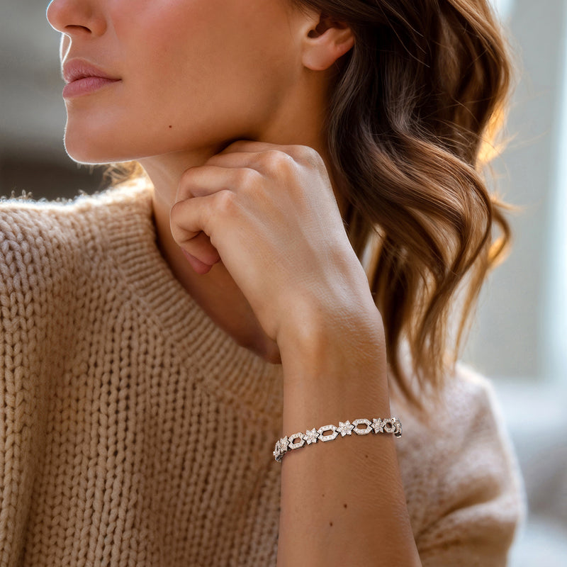Diamond oval and flower-link bracelet worn on wrist in 14kt white gold