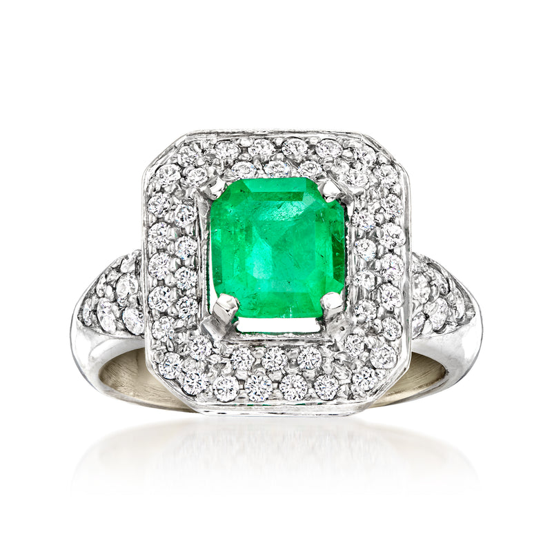 18kt white gold ring with square emerald center and diamond halo, visible prongs