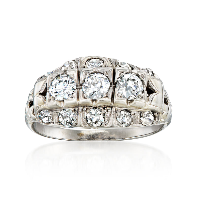 White gold diamond filigree ring with five round-cut stones in a row
