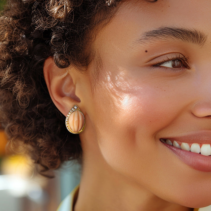 Diamond halo coral teardrop earrings shown on-wear, 18kt yellow gold